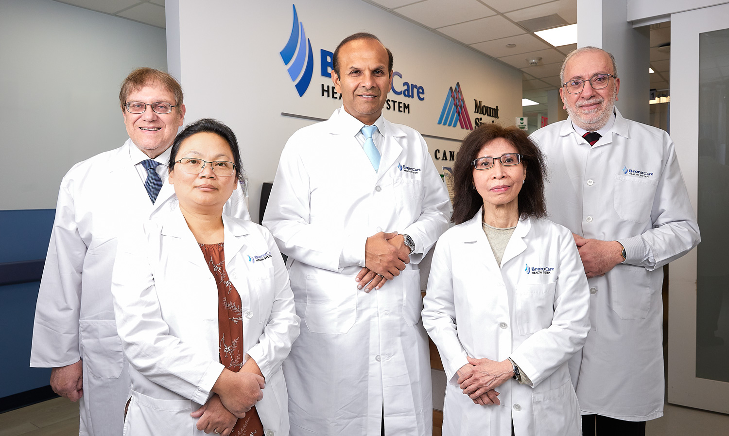 Dr. Kevin R. Jain, Director, BronxCare Mount Sinai Comprehensive Cancer Care/Chief, Medical Oncology and Hematology (center), with Oncology Physician team (L to R): Dr. Philip Rubin, Attending, Dr. Valentina Moirangthem, Attending, Dr. Thanh-Ha Luong, Attending, and Dr. Anas El Mogharbel, Attending.