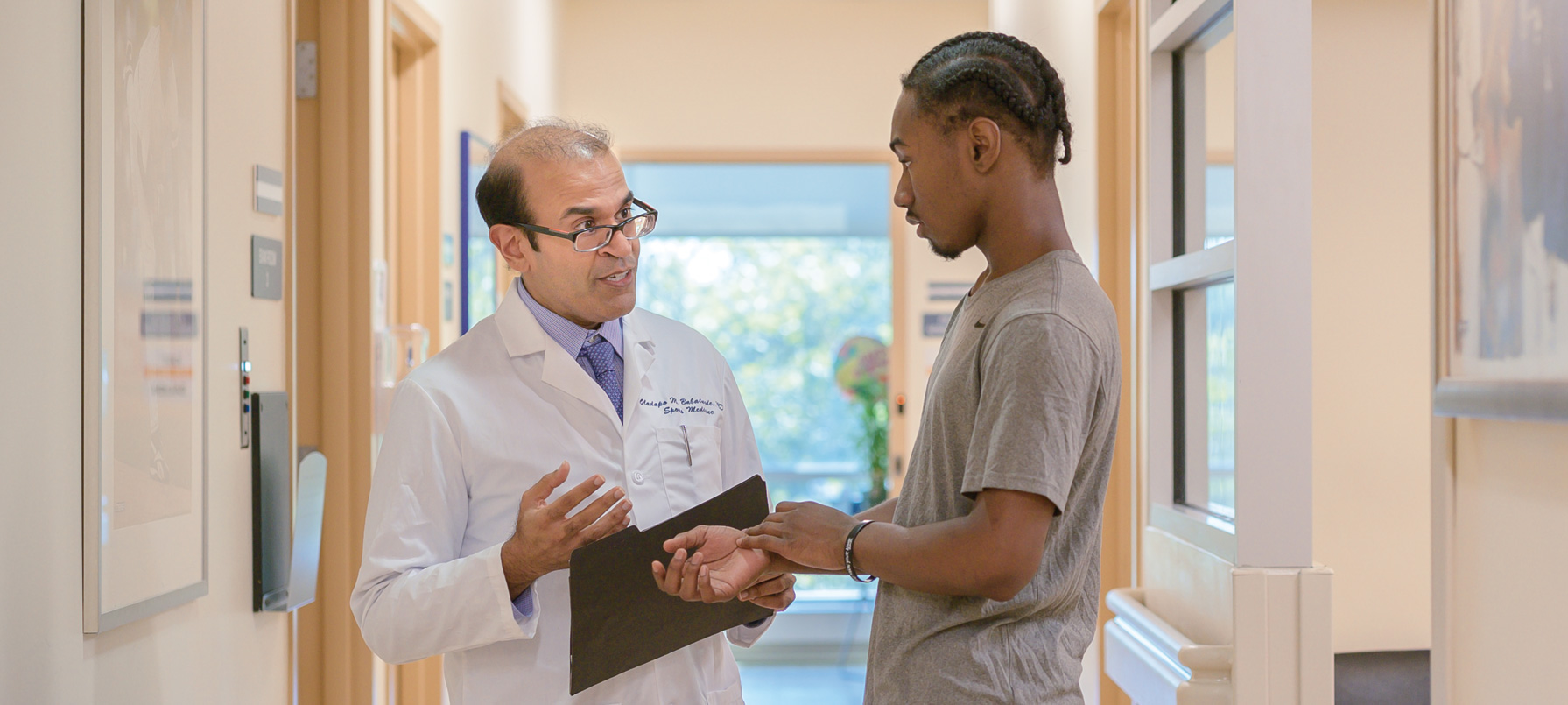 Dr. Ashok Dubey, Director of Outpatient Orthopaedics, discussing treatment plan with patient.