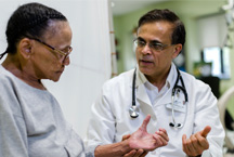 Dr. Sumir Sahgal, Medical Director, Special Care Center, attending to resident.