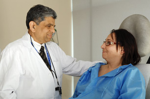 Dr. Ajay Shah, Vice Chairman/Program Director, Surgery, comforting patient.