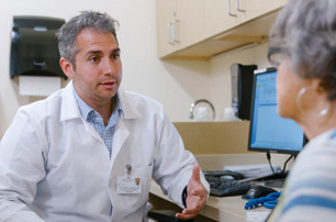 Dr. Matthew Furman, Attending, Surgical Oncology, consulting with patient.