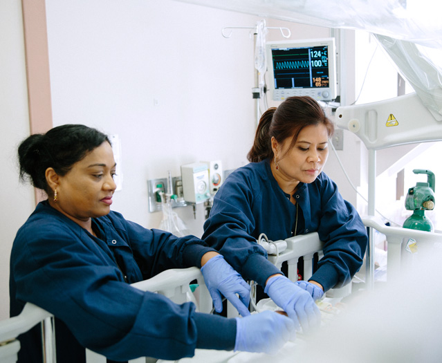 (L to R): Ramakumarie Ramdass, Patient Care Technician, and Evelyn Camacho, RN, in Post Anesthesia Care Unit.