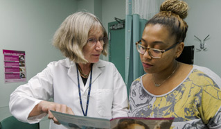 Dr. Harriet Smith, Director, Gynecologic Oncology, instructing patient.