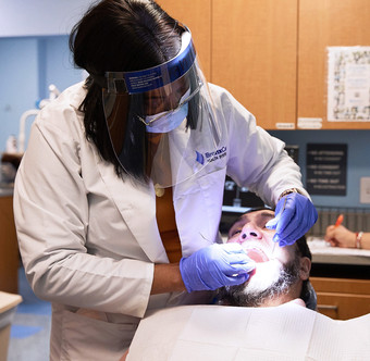 Dr. Ngozi Ubu, Clinical Director, examining patient.