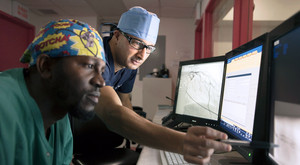 Dr. Nassim Krim, Director, Cardiac Catheterization Lab/Interventional Cardiology (right), reviewing cardiac image with Windinmi Ouedraogo, Cardiac Catheterization Lab Technician.