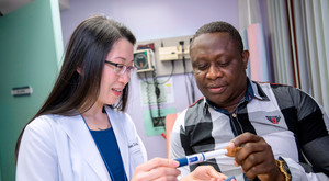 Dr. Vivien Leung, Chief, Division of Endocrinology, instructing patient.