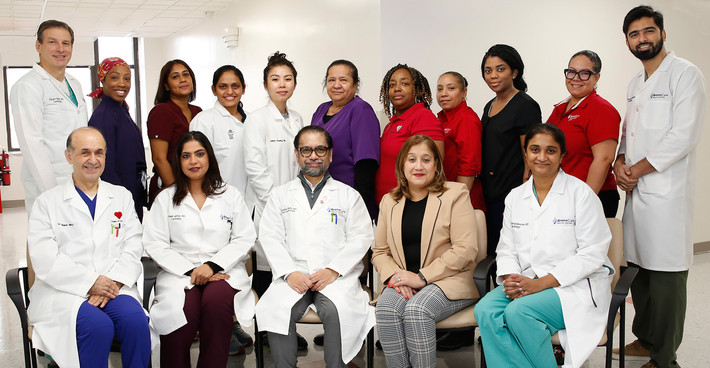 Dr. Jonathan Bella, Chief, Cardiology (seated, center), and Diana Cruz, Practice Administrator, Cardiology (seated, second from right), with Cardiology team.